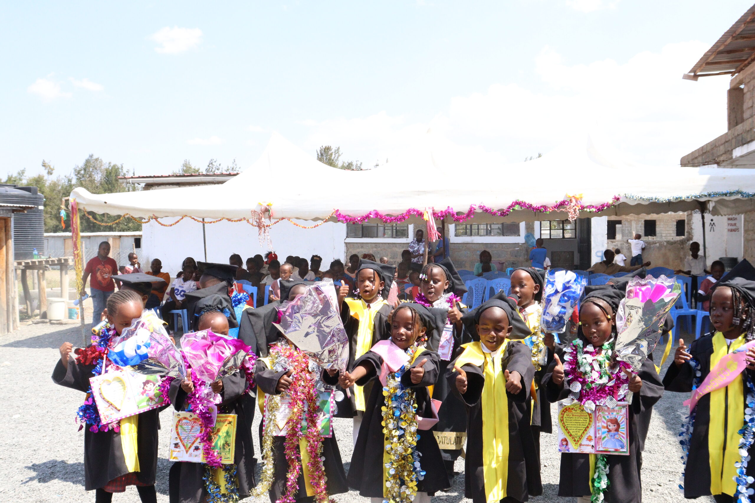 Kuza pupils celebrating a school milestone with their community