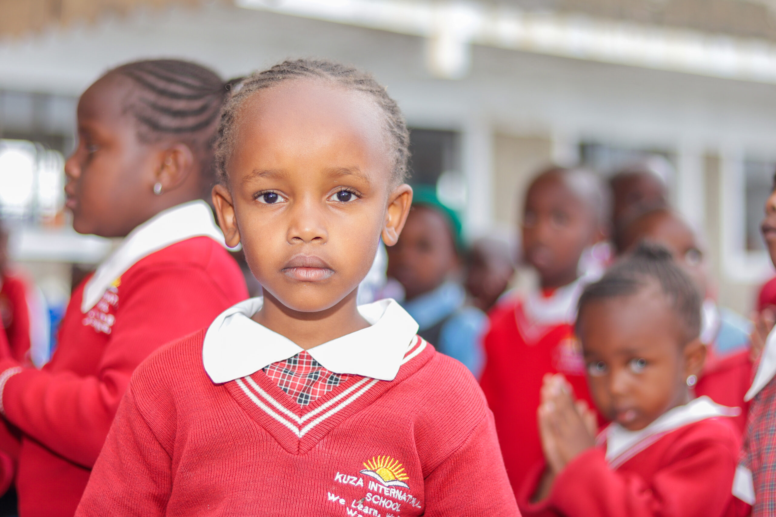 A learner in Kuza’s red school uniform